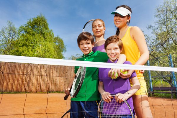 Happy family after playing tennis in summertime