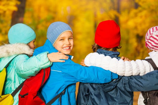 Back view of happy children with rucksacks